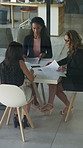 Above, meeting and business women with documents for finance report, budget and portfolio. Team, office and workers with paperwork in discussion for financial strategy, proposal and investment option