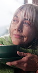 Reflection, coffee and senior woman in home for inspiration, wondering and nostalgia for cold weather. Happy, thinking and mature person with beverage, drink or tea for calm, peace and wellness