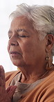 Prayer, faith or senior woman in home for hope, worship or spiritual connection with Jesus Christ. Religion, elderly person and praying to God for forgiveness, holy guidance and devotion at house
