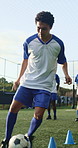 Man, running and soccer ball with cone for training, fitness and team outdoor for competition practice. Athlete, person and football player on field with sports drill, skill development or equipment.