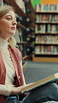Education, reading and thinking with woman in library of college or university for learning. Book, idea and study with scholarship student on floor at school for development, information or knowledge
