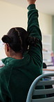 Learning, kid and hands up for question in class, knowledge and development in elementary school. Girl, education and student with answer at lesson, asking and participation with engagement from back