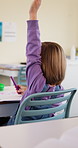 Learning, kid and raised hand for question in class, knowledge and development in school. Girl, education or student with answer for quiz, ask and lesson participation with engagement from back