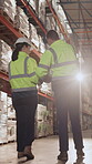 Back, planning and walking with people in logistics warehouse for distribution or storage. Conversation, inventory and stock with supply chain in depot together for delivery or shipping agenda