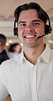 Face, smile and man in call center for help service, customer support or coworking with bokeh. Portrait, headset and happy consultant in office for virtual assistance, contact us and pride for career