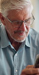 Mature, man and smile in home with phone, social media and browsing website for online news on weekend. Happy, person relax and reading in house with tech, glasses and mobile app for digital article.