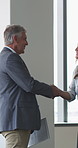 Handshake, documents and business people in lobby for meeting, welcome and onboarding. Corporate, office and workers shaking hands for collaboration with financial proposal, negotiation and b2b deal