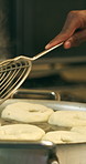 Chef, hands and cooking in pot with dough, restaurant cuisine and boiling water for bagel recipe. Baker, person and tools in bakery kitchen with meal prep, catering and hot stove to steam bread roll.
