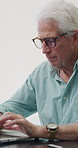 Senior man, writer and typing with laptop in home for online story, publish or digital novel. Freelancer, author or elderly male person with glasses or spectacles on computer for ebook or manuscript