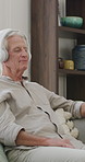 Old man, home and calm with headphones for music, streaming and song selection with phone in lounge. Happy, elderly person and listening to audio with tech, retirement and scroll on mobile in house