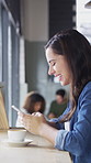 Cafe, coffee and happy woman with phone for chat, texting and reading funny message on social media. Customer, face and person with mobile for communication, laugh and drinking latte on break in shop