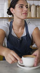 Hospitality, serving and woman in cafe with coffee, giving drink or friendly service at bistro. Smile, barista or customer in store with warm beverage, latte handover or order pickup in restaurant.