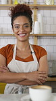 Serving, woman and face of barista in cafe with coffee for customer order, service or hospitality career. Portrait, crossed arms and female waitress with warm beverage mug for purchase in restaurant.