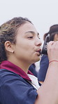 Woman, team and drinking water at university with sport practice, bottle or training break for wellness. Thirsty, person and hydration on field outdoor with college rugby group, exercise and fitness.