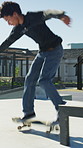 Man, skateboard and jump on rail in city, tricks or balance for grinding at urban park. People, skater and extreme sports in town for exercise, practice or sunshine with training for stunt in summer