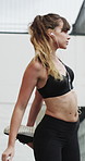 Woman, earphones and stretching with legs in city for wellness, muscle and streaming in morning. Girl, warm up and listen to music with fitness with audio, subscription and sound in urban town