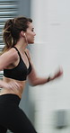 Running, exercise and woman in city with earphones for fitness, cardio workout and training. Runner, sports and person with active hobby for wellness, health and endurance with music, audio and track