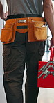 Back, toolbox and plumber walking in kitchen for maintenance, service and home repair. Equipment, handyman and contractor person with tools in house for plumbing inspection, upgrade or improvement