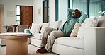 Relax, calm and black man on sofa in home with peace, stress free or break on weekend in lounge. Rest, day off and mature African male person with chilling on couch in living room at apartment.