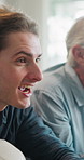 Football, watching tv and man with senior father on sofa in home for bonding, esports or online tournament. Excited, relax and person with elderly dad for streaming soccer match together in house.