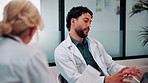 Doctor, team and conversation in hospital with laptop, research and review for patient test results. Healthcare, people and talk in clinic with computer, planning or collaboration for medical report.