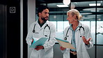 Team, walking and talking with document for healthcare review, treatment planning and advice in clinic. Doctors, people and folder in hospital for medical schedule, meeting and problem solving