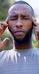 Fitness, headache and black man with stress in nature for outdoor workout, accident or strain. Active, exhausted or male person with migraine, pressure or massage for muscle tension or fibromyalgia