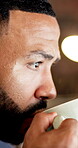 Coffee, man and reading with insight in office for article draft, fact checking submission or night. Productivity, editor and beverage at media agency for story review, proofreading or blog deadline