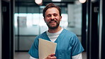 Healthcare, face and nurse with folder in clinic for treatment records, medical service or pride. Professional, happy man or paperwork in hospital hallway for test results, clinical notes or about us
