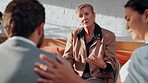 Therapist, meeting and group counseling in workplace with conversation, wellness tips and empathy. Mature woman, psychologist and business people with mental health advice, help or therapy discussion