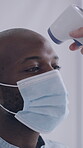 Medical, face mask or man with screening, thermometer or fever check in virus evaluation. Healthcare, review or people with scanner, risk assessment or wellness procedure with infection prevention.