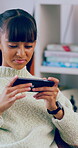 Phone, smile and teenage girl in home with internet connection, social media post and app online. Female person, cellphone or technology with scroll for website search, gaming or relax in house