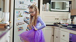 Creative, dance and child with ballet in home for recital practice, flexible movement or growth. Girl kid, ballerina or routine with tutu in kitchen for learning steps, physical development or skill