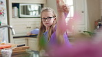 Stretching, ballet and child in kitchen at home, warm up routine and getting ready for dance practice. Concentration, balance and girl with preparation for rehearsal, flexibility development or tutu