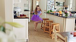 Kid, kitchen and dance with energy, freedom and creative performance with dress for music in morning. Girl, child or moving with talent for rhythm at home, tutu and spin for weekend celebration