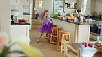 Kid, kitchen and dance with energy, jump and creative performance with dress for music in morning. Girl, child or moving with talent for rhythm at home, tutu and weekend celebration with freedom