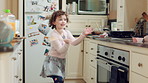 Dancing, smile and child with spoon in kitchen for weekend fun, energy and motor skill development. Childhood, utensil and girl with playful expression of happiness, home and movement for music