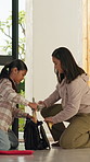 Backpack, help and mother with girl, late and rushing for education, support and deadline. Back to school, student and multitasking with morning routine, mom and child in apartment for getting ready