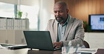 Black man, document and laptop in office for project management, report or email at PR agency. Business person, typing and mature public relations manager with tech with paperwork or communication