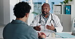 Hospital, talking and doctor with patient for medical advice, visit or healthcare appointment. Discussion, professional and man with wellness consultation, explaining or checklist of diagnosis