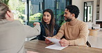 Financial advisor, handshake and document with couple in home for budget review or investment planning. Paperwork, conversation and shaking hands with people in house for finance or wealth management