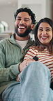 Couple, laugh and relax with remote in lounge, point and excited for comedy movie and entertainment. Happy people, watching tv and bonding with funny series on break, together or film choice in house