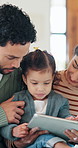 Family, scroll and child with tablet in lounge, education or development with elearning app in house. People, online and girl with tech for fine motor skills, happy and bonding with parents in home