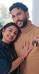 Face, moving and couple with key in new home, smile and property investment with partner. Happy man, woman and relocation with keychain for mortgage, real estate and hug for love at dream house