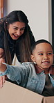 Box, mom and child play in new home for bonding, happiness and real estate celebration. Family, moving and homeowner or woman with kid excited, game and running in house for relocation success