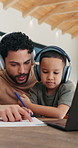Teaching, dad and child in home for online learning, writing and language development. Headphones, tech and family or man helping with kid for education, listening to audio and practice on paper