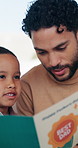 Father, child and reading book in home for learning, growth and language development with parent. Dad, boy and storytelling at apartment for bonding together, education and support with knowledge