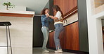 Dance, smile and mom with girl in kitchen for happy, celebration and bonding. Low angle, movement and music with woman and child in family home for support, weekend or holding hands for entertainment