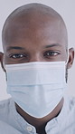 Face mask, black man and doctor in clinic with confidence for safety protocol for medical career. Hospital compliance, about us and portrait of African healthcare worker with pride for protection.