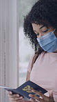 Woman, face mask and passport at airport for travel with restrictions, compliance or identity. Person, plane ticket and booking for flight with paperwork, ppe and check boarding pass for immigration